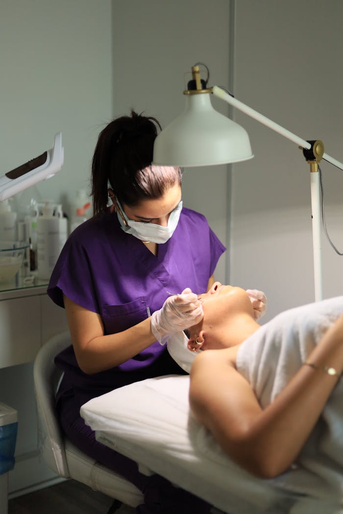 A skincare professional performs a facial procedure in an Istanbul clinic.